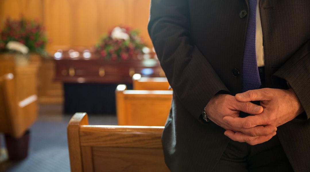 man standing in a funeral setting